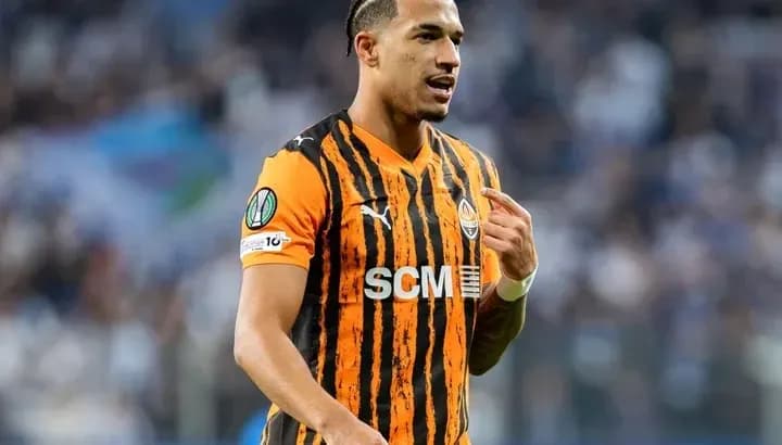 Player in orange and black jersey during match