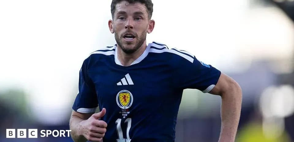 Scottish player running during a football match