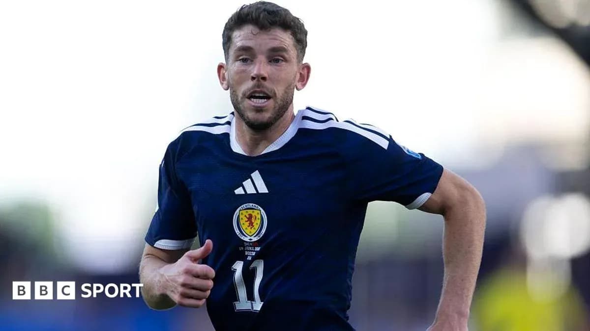 Scottish player running during a football match