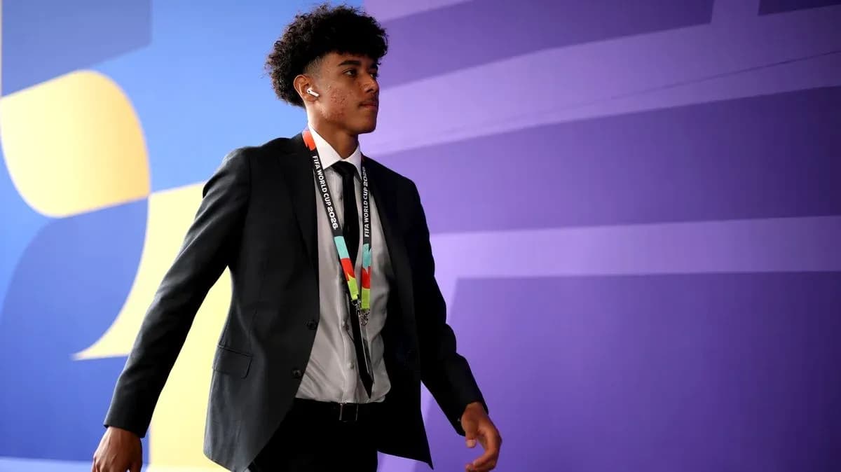 Player walking in formal attire with accreditation
