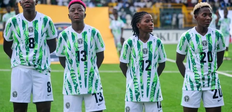 Four Nigerian players in team jerseys standing together
