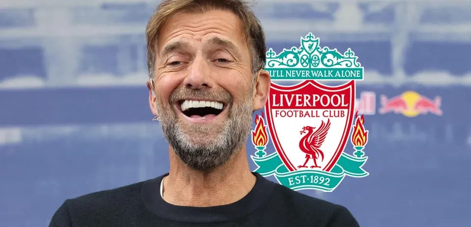 Manager smiling at press conference with club logo