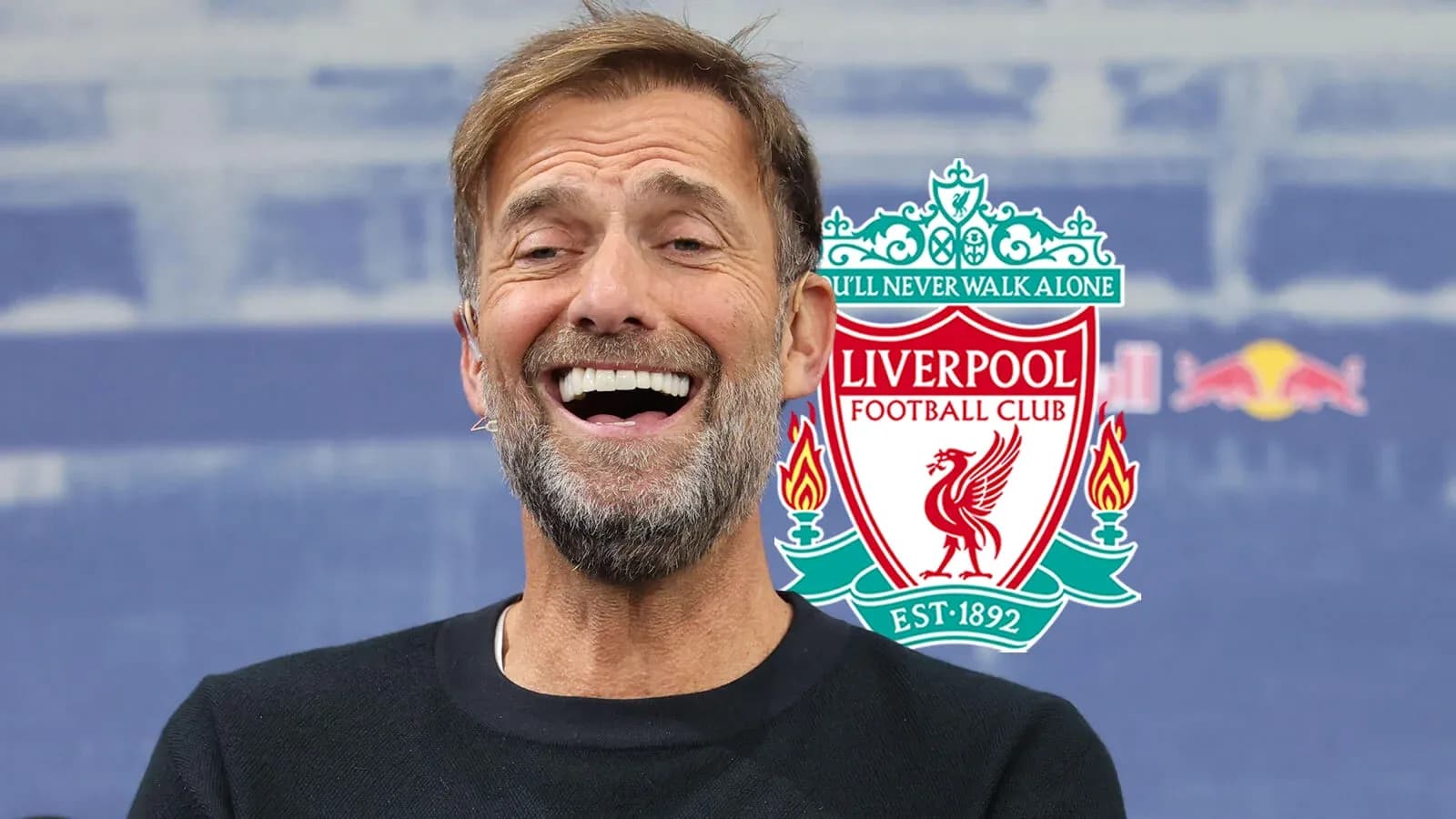 Manager smiling at press conference with club logo
