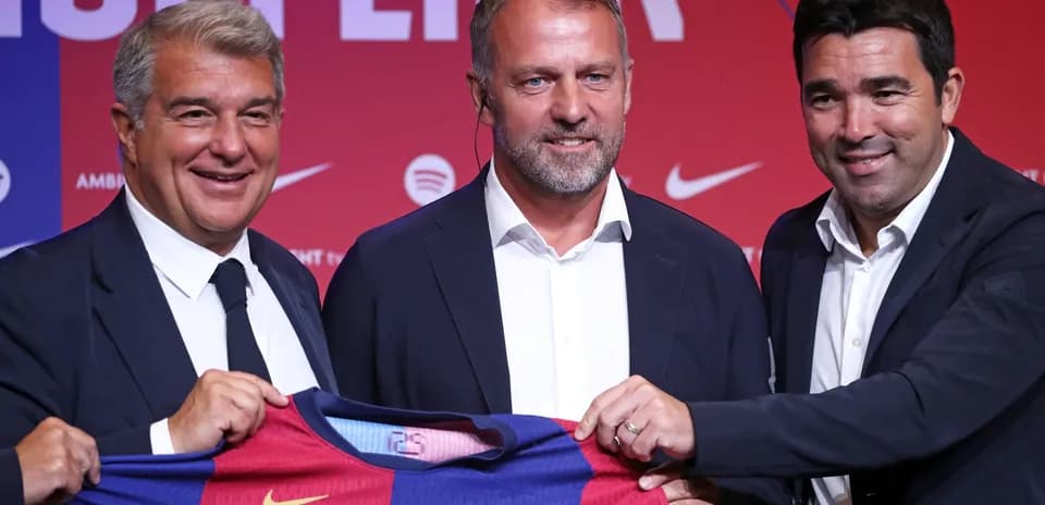 Three officials holding Barcelona jersey at presentation