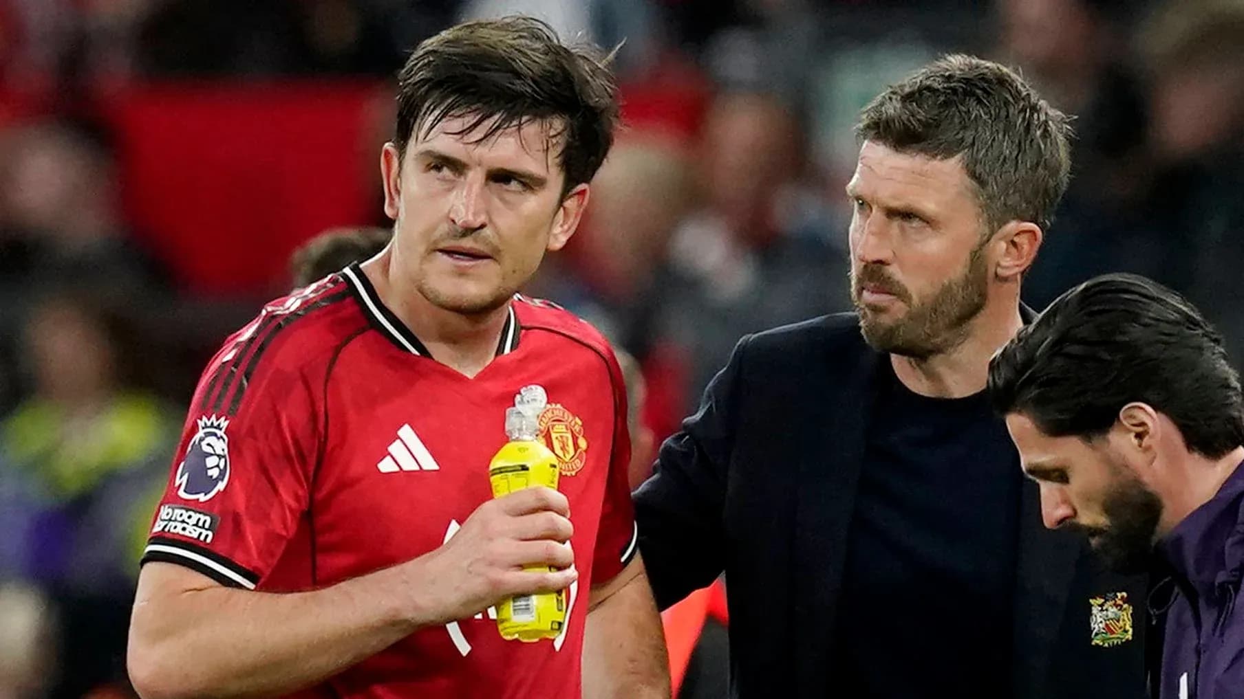 Player receiving attention from coach during match