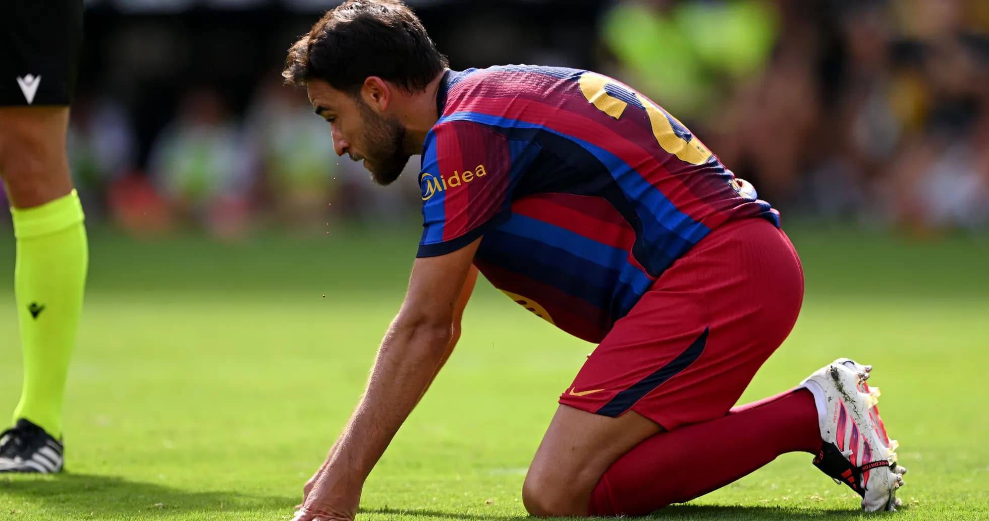 Player kneeling on the pitch during a match