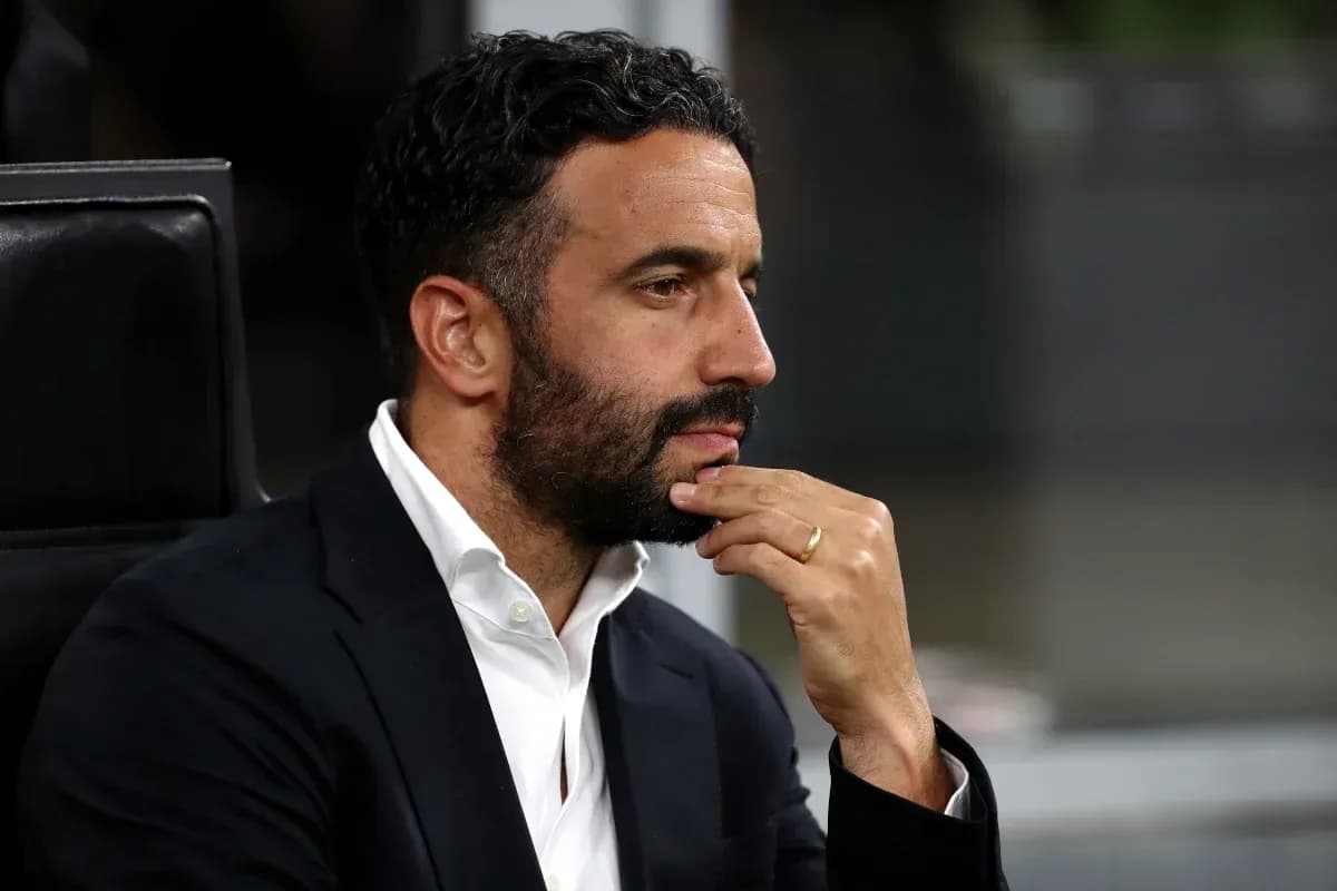 Man in suit with hand on chin during match