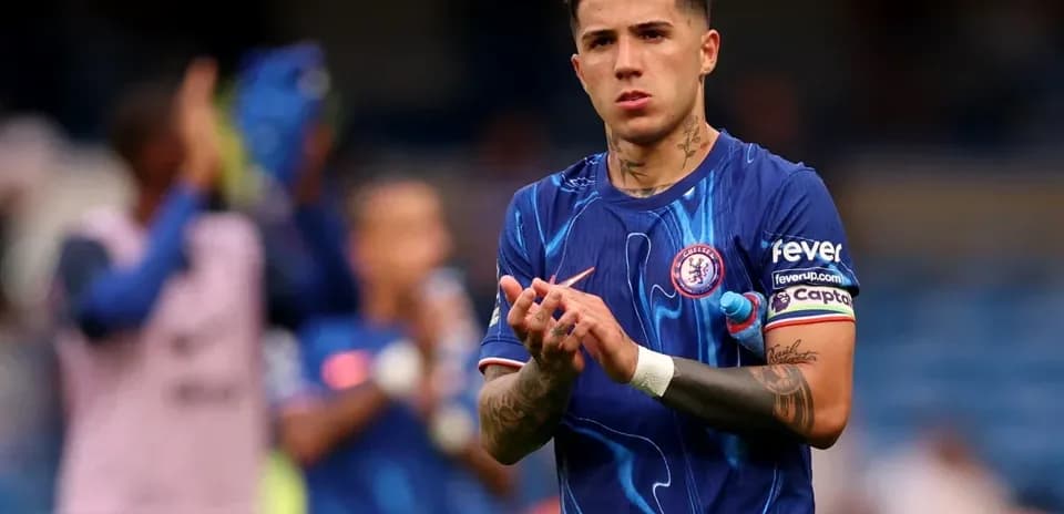 Player applauding fans while wearing Chelsea kit