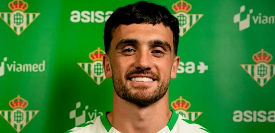 Player posing in front of green club backdrop