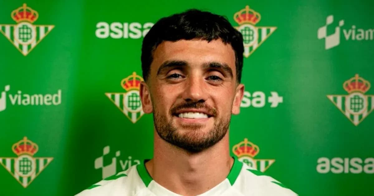 Player posing in front of green club backdrop