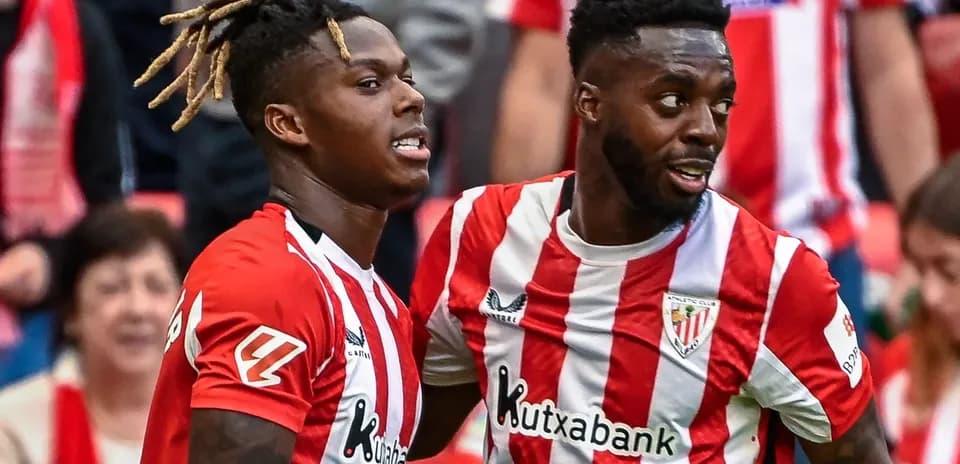 Two Athletic Club players celebrating a goal together