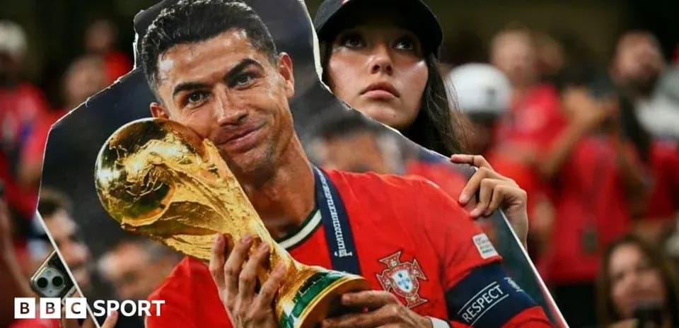 Fan holding Cristiano Ronaldo cutout with trophy