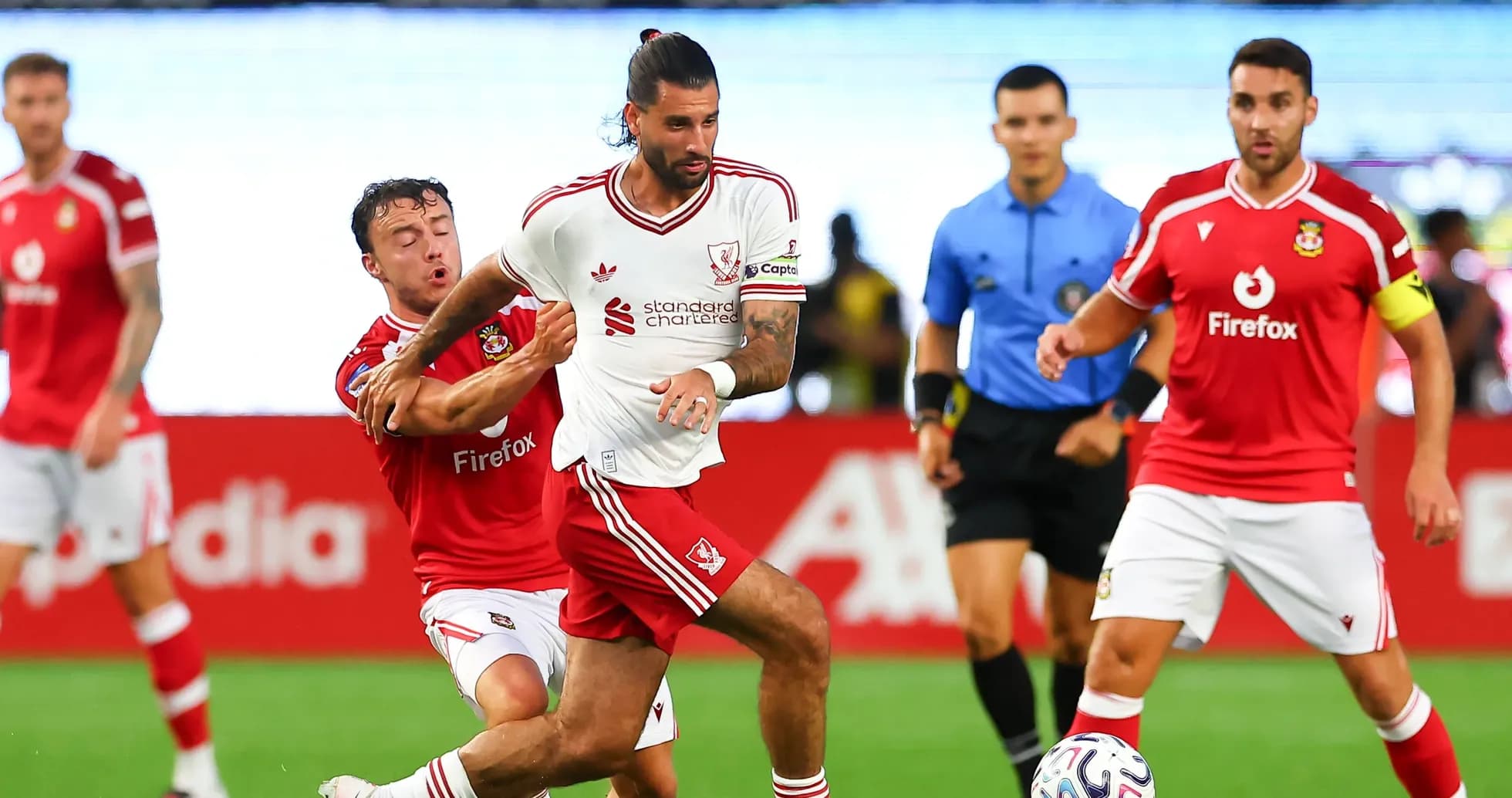Player in white jersey evading a tackle during match