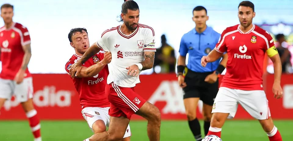 Player in white jersey evading a tackle during match