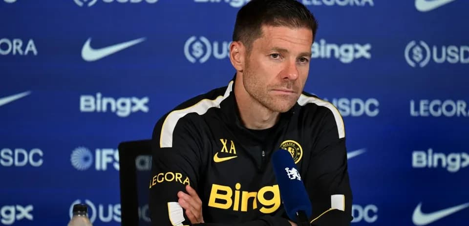 Manager speaking at press conference with microphone