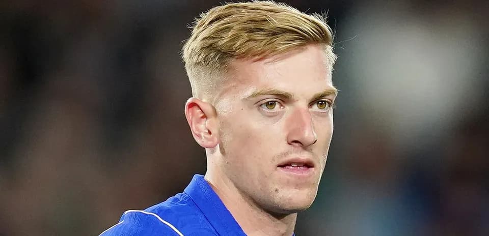Football player in blue kit during match