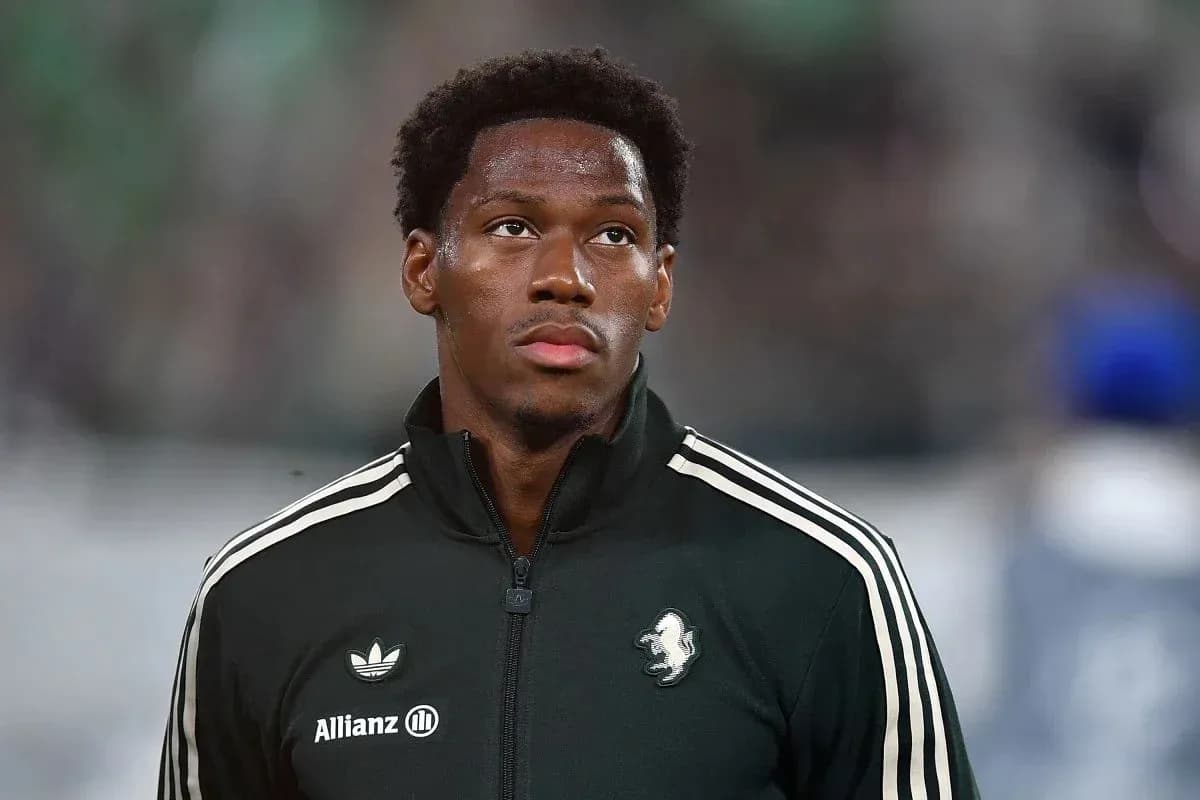 Player in black training jacket before match