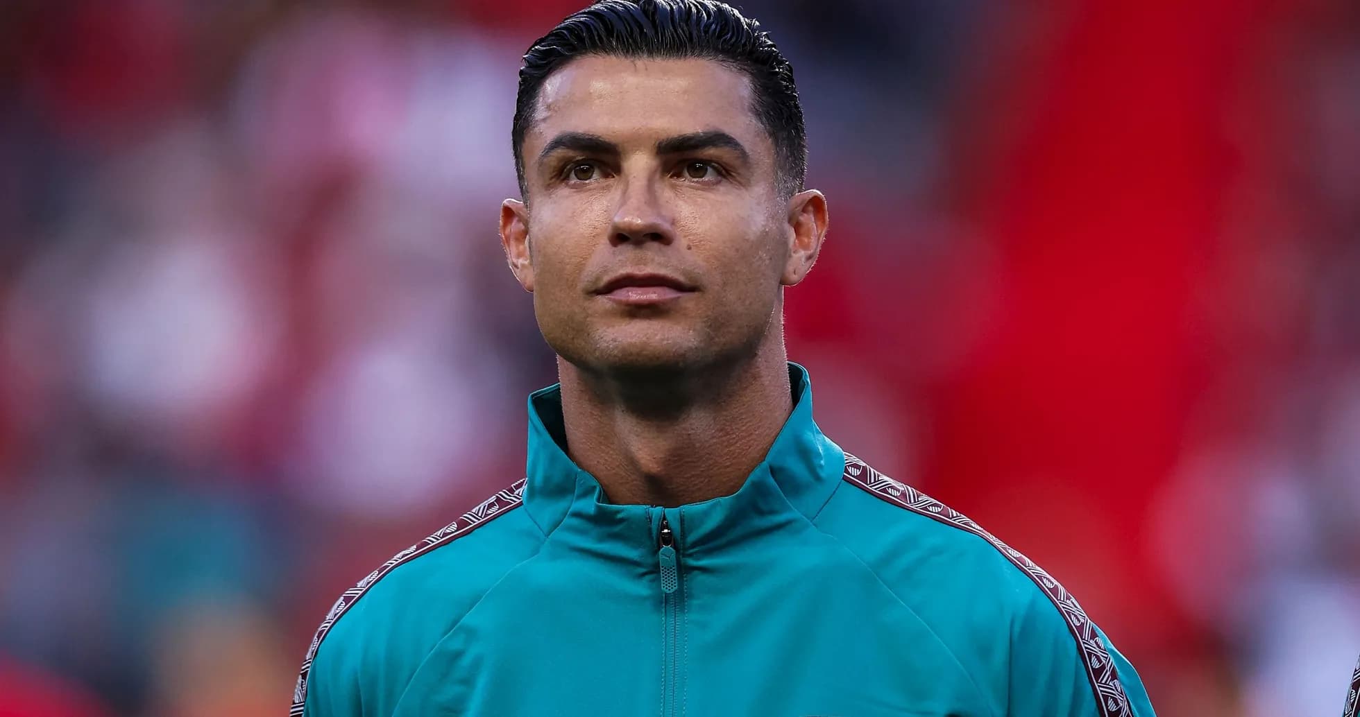 Player in teal training jacket during match preparation