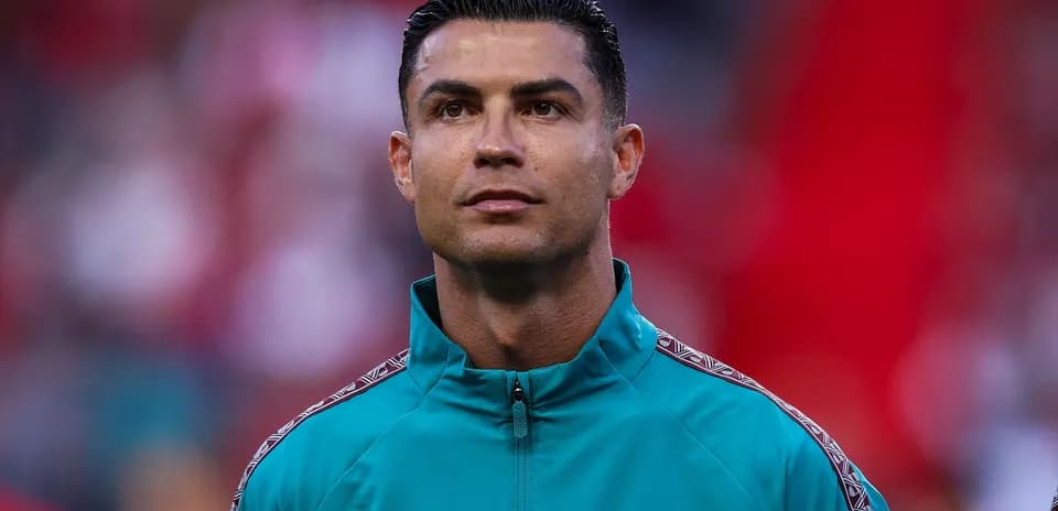 Player in teal training jacket during match preparation