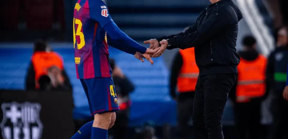 Player and coach exchanging handshake on field