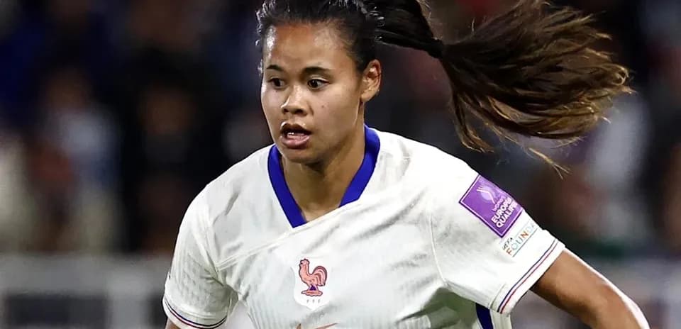 Player in white jersey running during a match