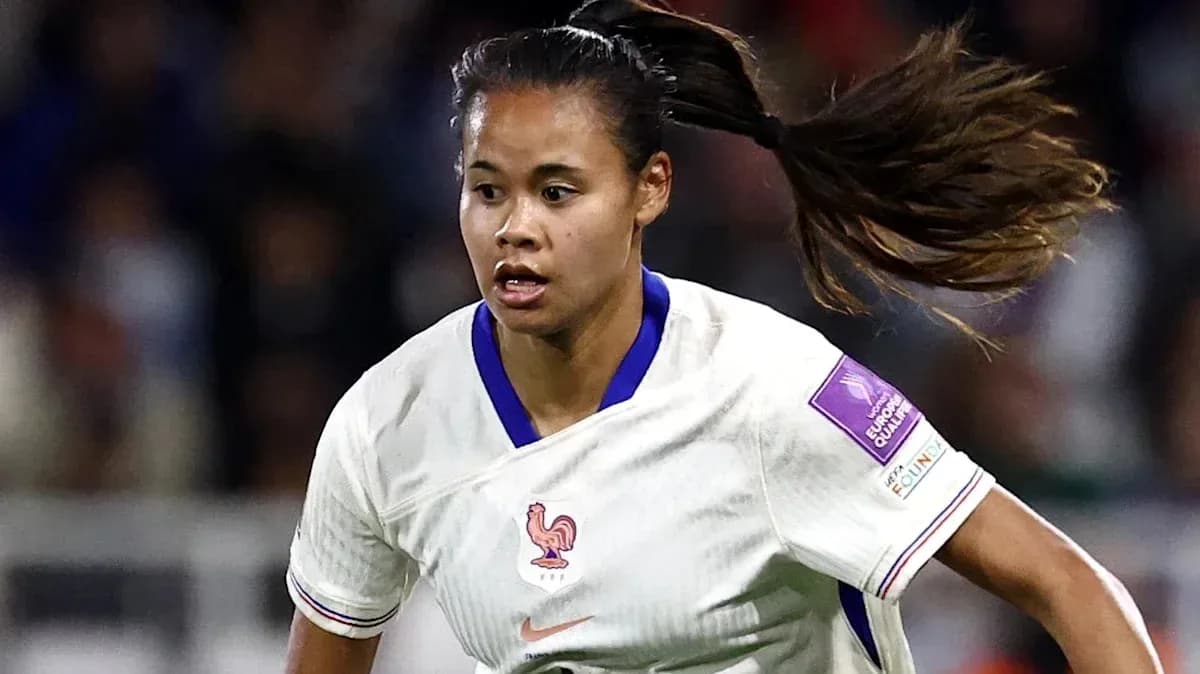 Player in white jersey running during a match