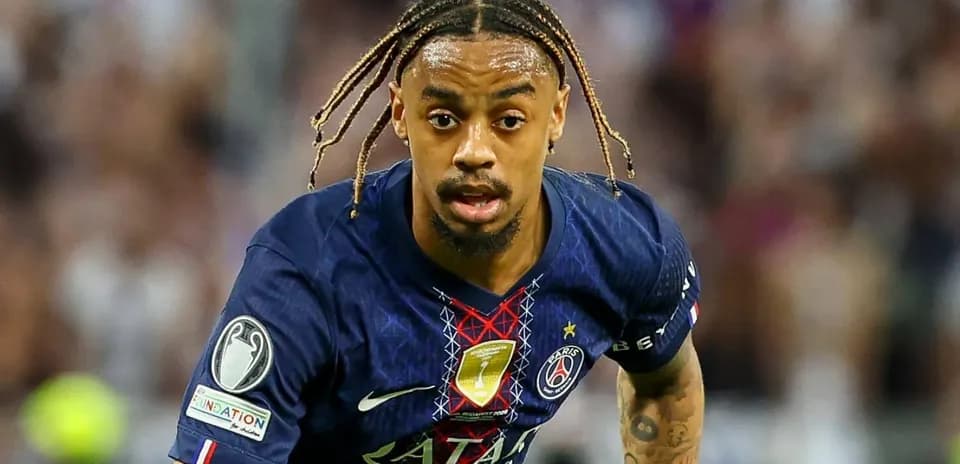 Player in Paris Saint-Germain kit running with ball