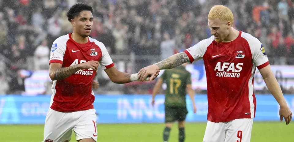 Two AZ Alkmaar players celebrating on the field