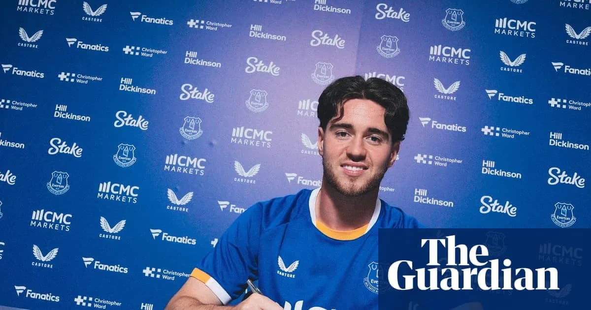 Player signing contract at Everton press conference