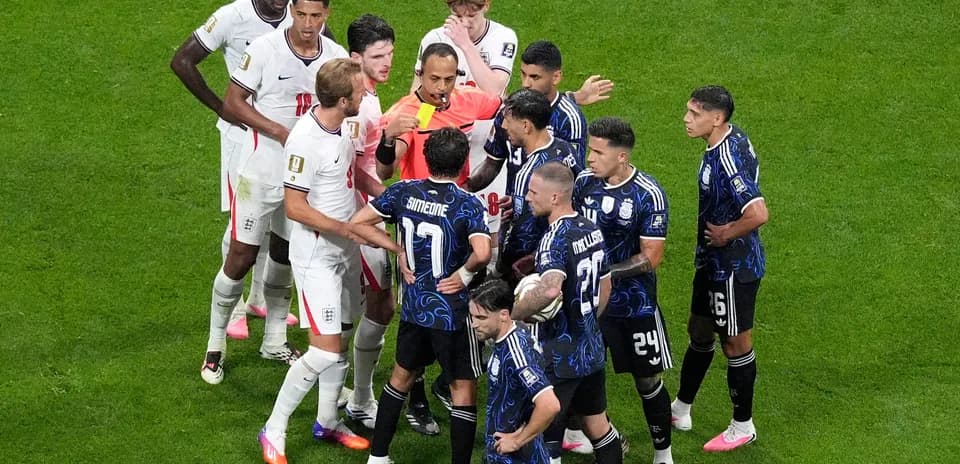 Players from England and Argentina arguing with referee