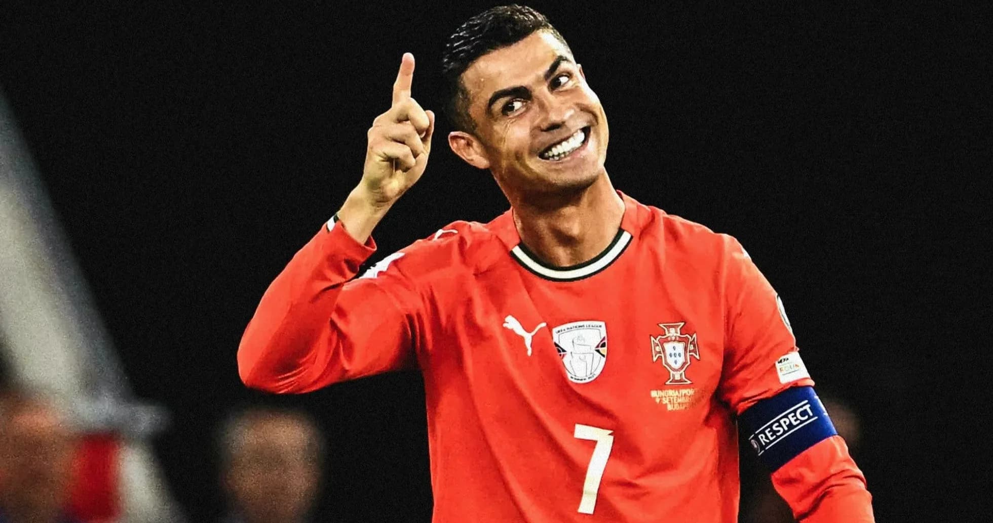 Player celebrating in Portugal's red jersey with raised finger