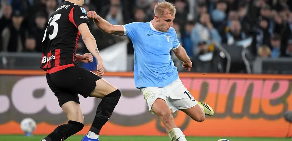 Lazio player tackling AC Milan opponent during match