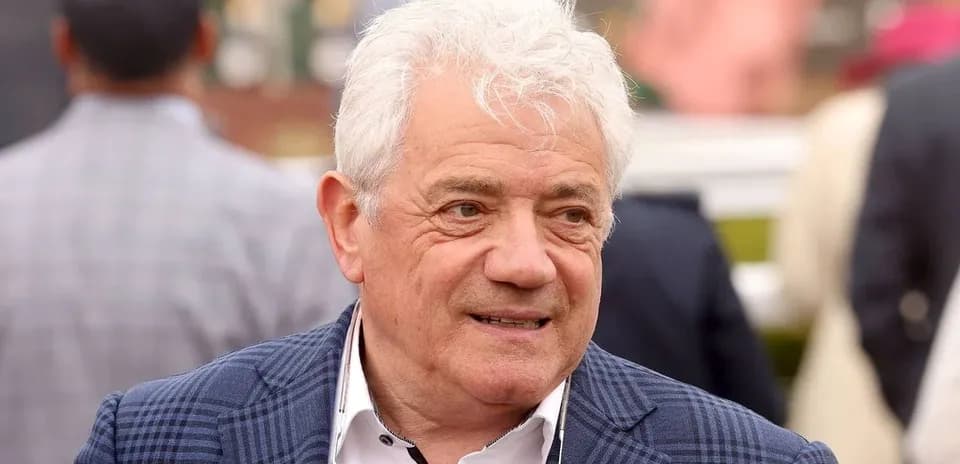 Man in a checkered blazer at an event