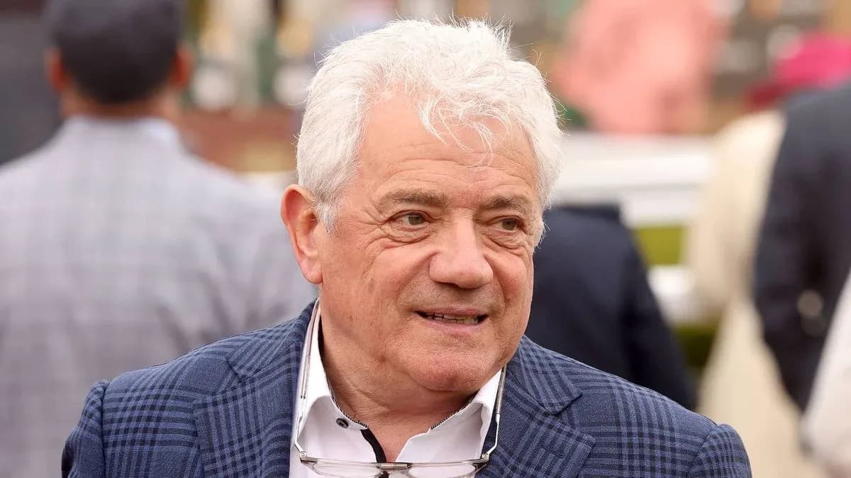 Man in a checkered blazer at an event