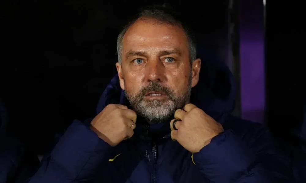 Coach adjusting jacket on the sidelines during match