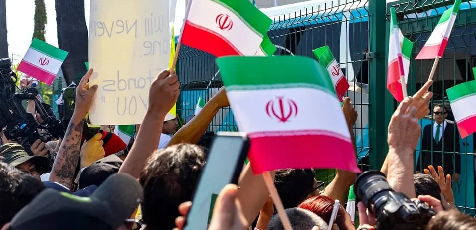 Crowd waving Iranian flags at protest rally