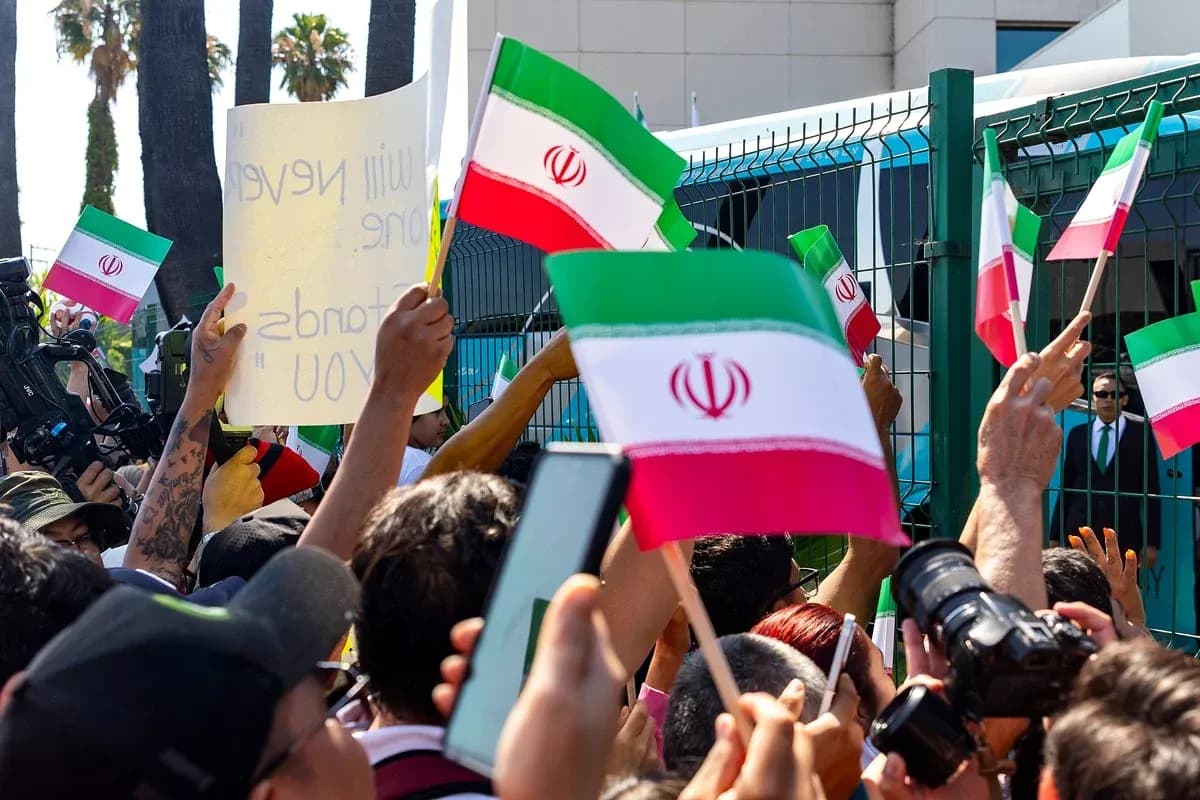 Crowd waving Iranian flags at protest rally