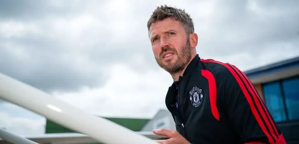 Coach in Manchester United training gear outdoors