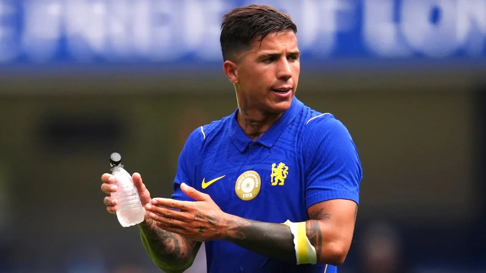 Player holding a water bottle during warm-up