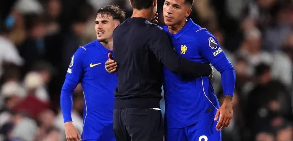 Chelsea players and manager embracing on the pitch