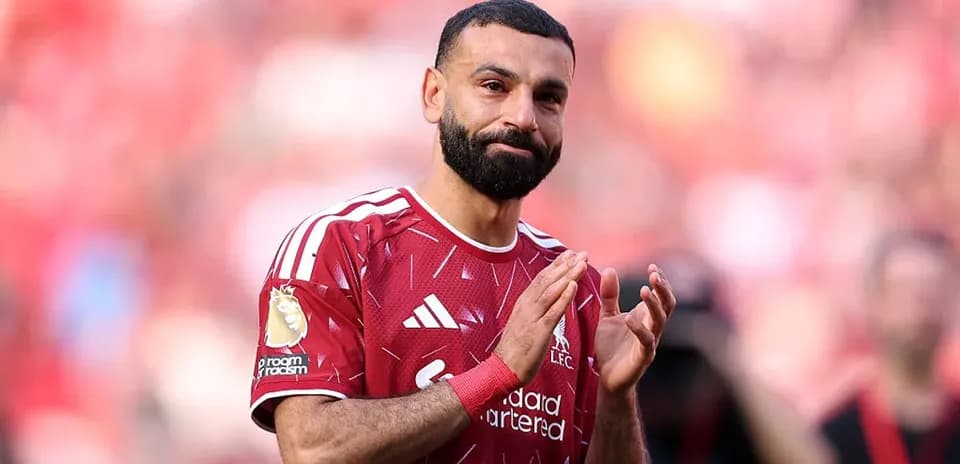 Player applauding fans in Liverpool home kit