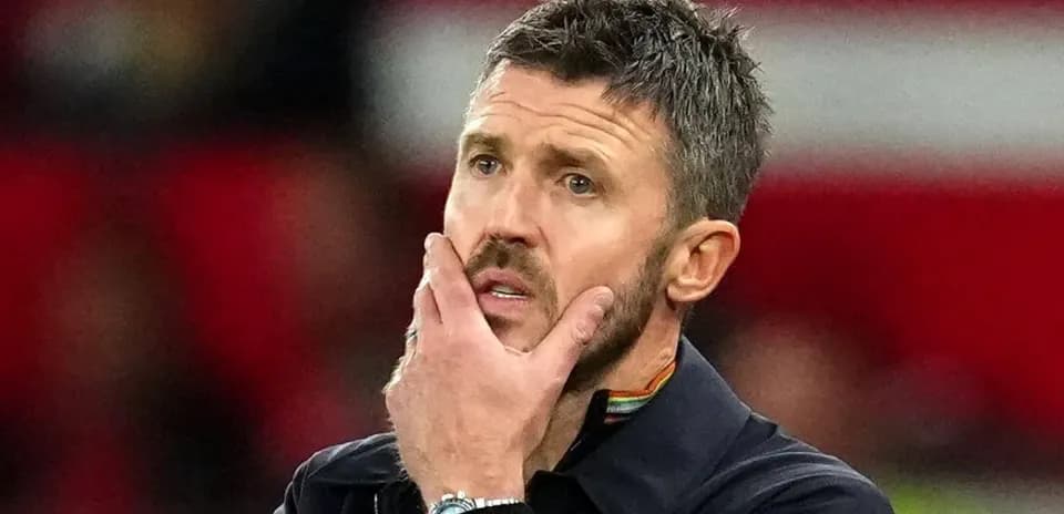 Coach with hand on chin during match