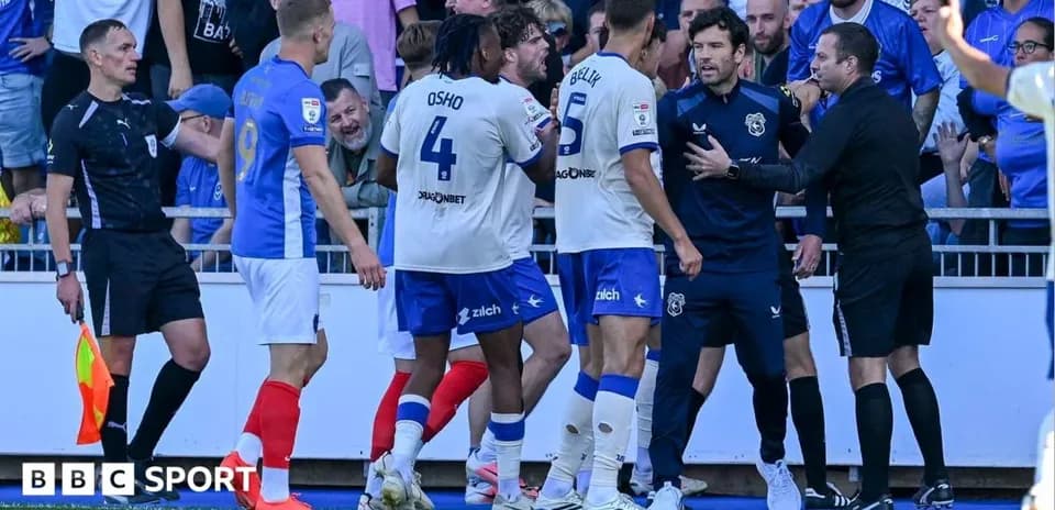 Players and officials in heated discussion during match