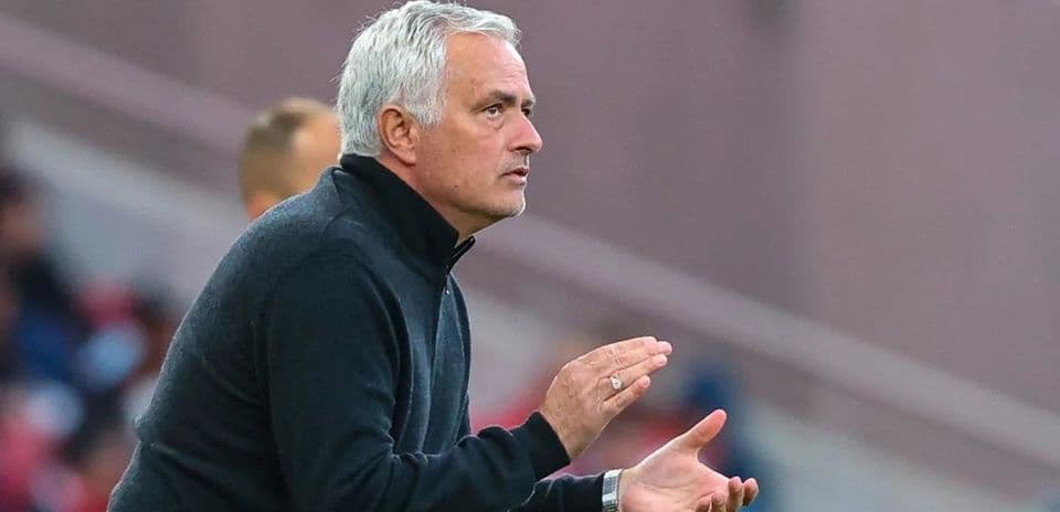 Manager gesturing during a match on the sidelines