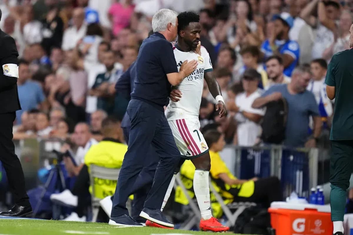 Coach guiding player off the pitch during match