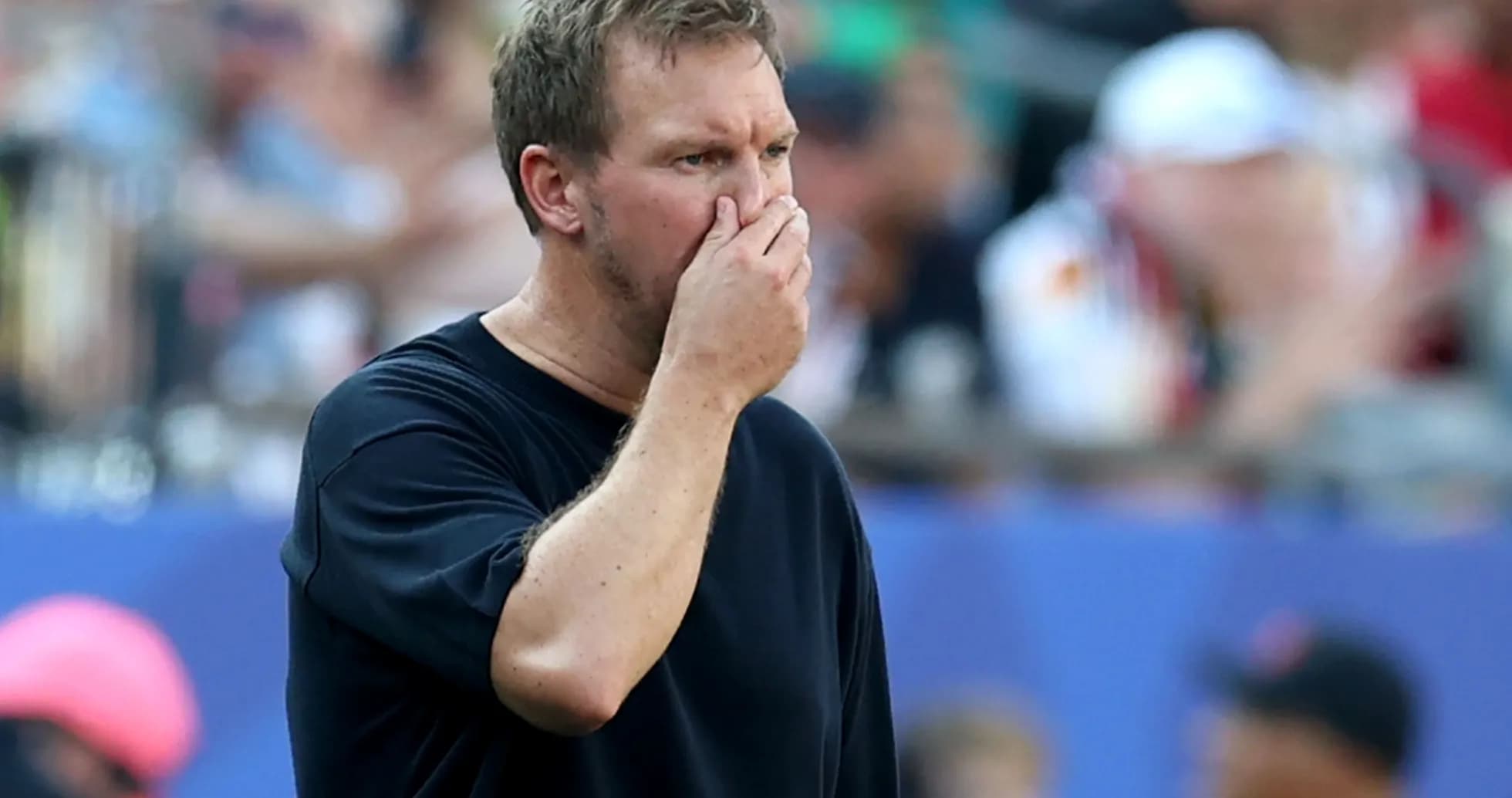 Coach observing the game with a concerned expression