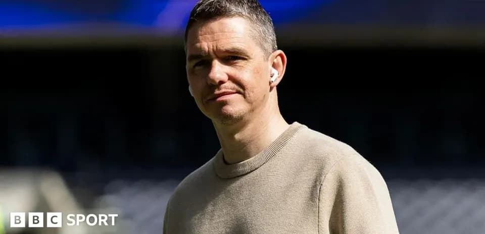 Man wearing headphones at a sports venue
