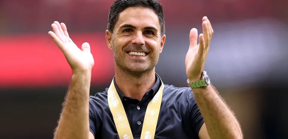 Coach celebrating with winner's medal and applause