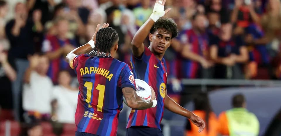Raphinha celebrating with teammate during match