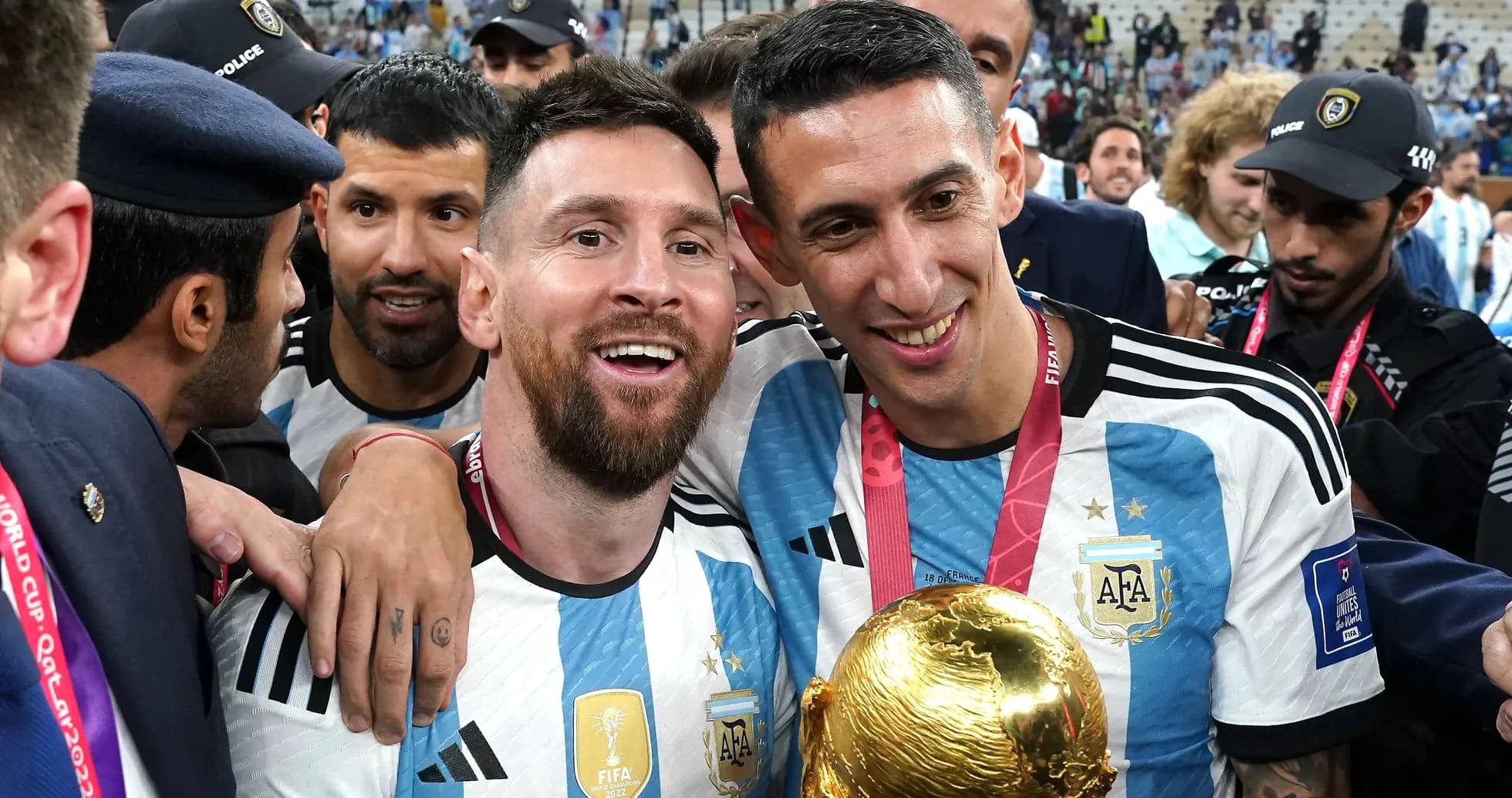 Messi and Di Maria celebrating with FIFA World Cup trophy